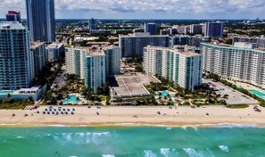 A coastal cityscape with high-rise buildings, a beach, and a swimming pool area. - 2Bed/2Bath, 4QueenBeds and OceanView at Tides (Hollywood)