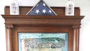 A wooden mantel with a framed map and two white lanterns. - Cedar Point - Sandusky Themed House (Sandusky)