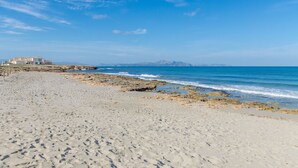 A beach with a building in the background.