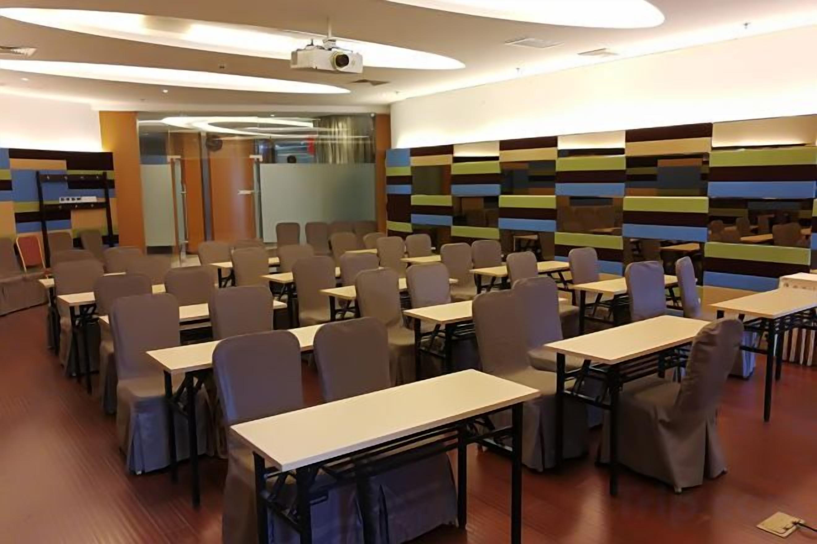 A conference room with tables and chairs arranged for meetings.