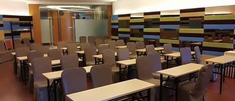 A conference room with tables and chairs arranged for meetings.