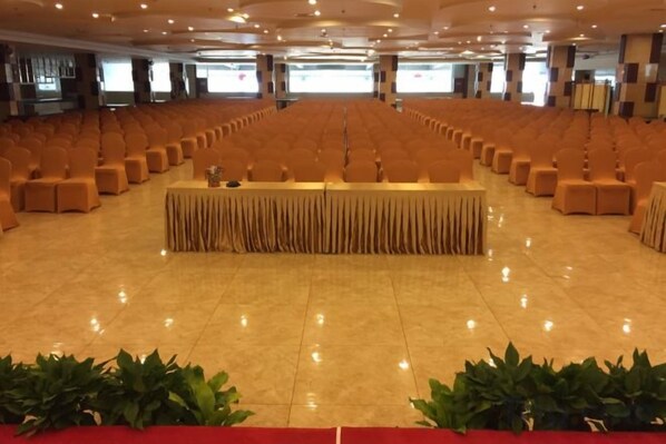 A large hall with rows of chairs and a central table, likely for events or conferences. - Nangong Hot Spring Health Hotel (Beijing)