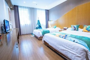 A hotel room with two beds, a TV, a wooden floor, and a window with curtains.