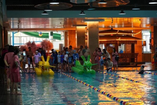 An indoor swimming pool with lanes, surrounded by spectators. - Nangong Hot Spring Health Hotel (Beijing)