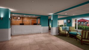 A reception area with a counter, chairs, and a clock. - Discover Coastal Charm at Marriott's Harbour Point in Hilton Head- 2 Bd. Villa (Hilton Head Island)