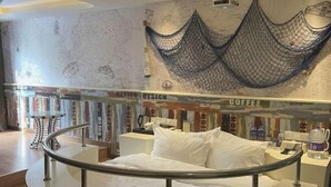 A bed with white bedding, a coffee station, and a map on the wall. - Laisili Hotel (Shanghai)
