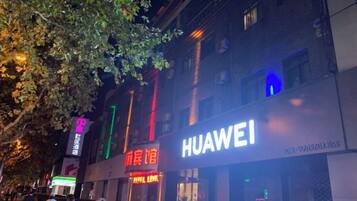 A building with a prominent Huawei sign, indicating a commercial establishment.