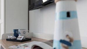 A table with a magazine, a coffee cup, and a tea bag.