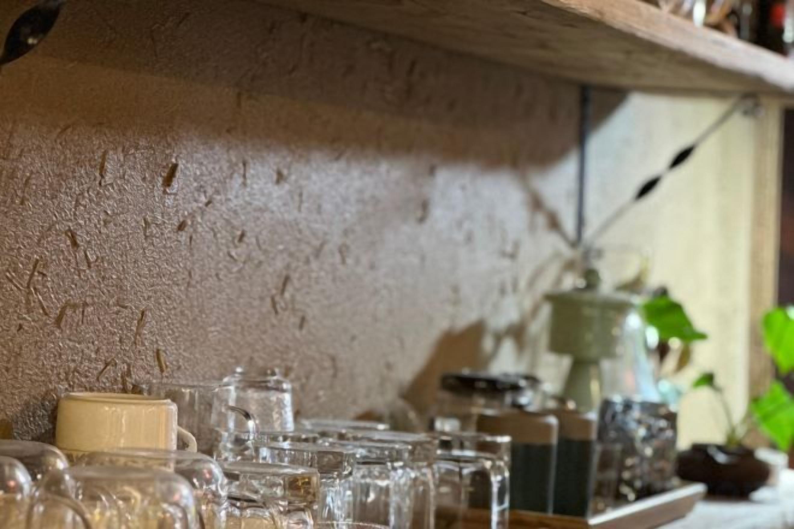 A kitchen counter with various glass containers and a ceramic pot.