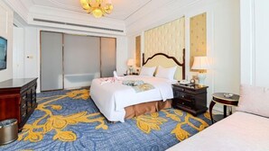A hotel room with a bed, bedside tables, a chandelier, a large mirror, and a patterned carpet. - Fucheng International Hotel (Sanhe)