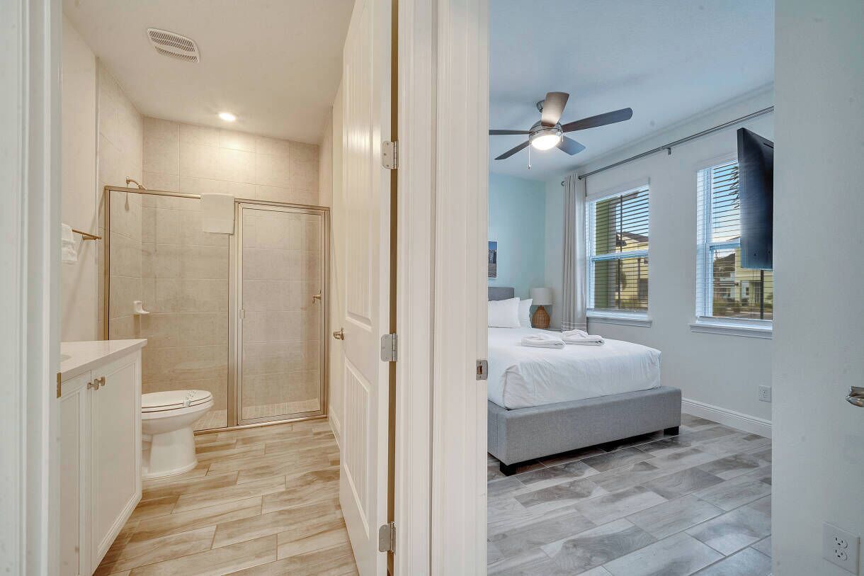 A modern bathroom with a shower, toilet, and vanity.