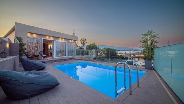 A rooftop pool with a clear view of the cityscape in the background.