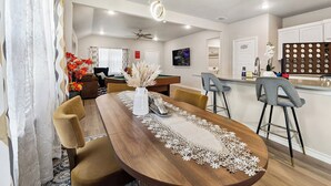 A modern dining area with a wooden table, chairs, and a decorative centerpiece. - Charming & Cozy in the Heart off LubbockPerfect forYour Getaway Close toTex Tech (Lubbock)