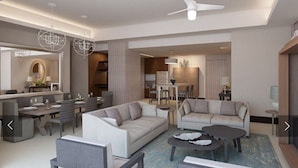 A modern living room with a sofa, coffee table, and dining area.