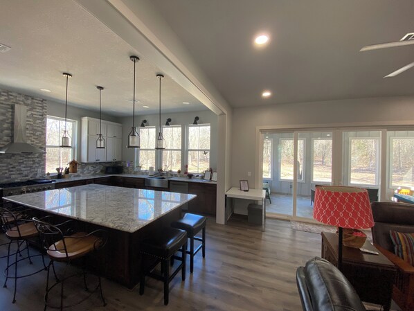 Enjoy meals in the kitchen with a large island and bar stools, offering ample workspace and seating.