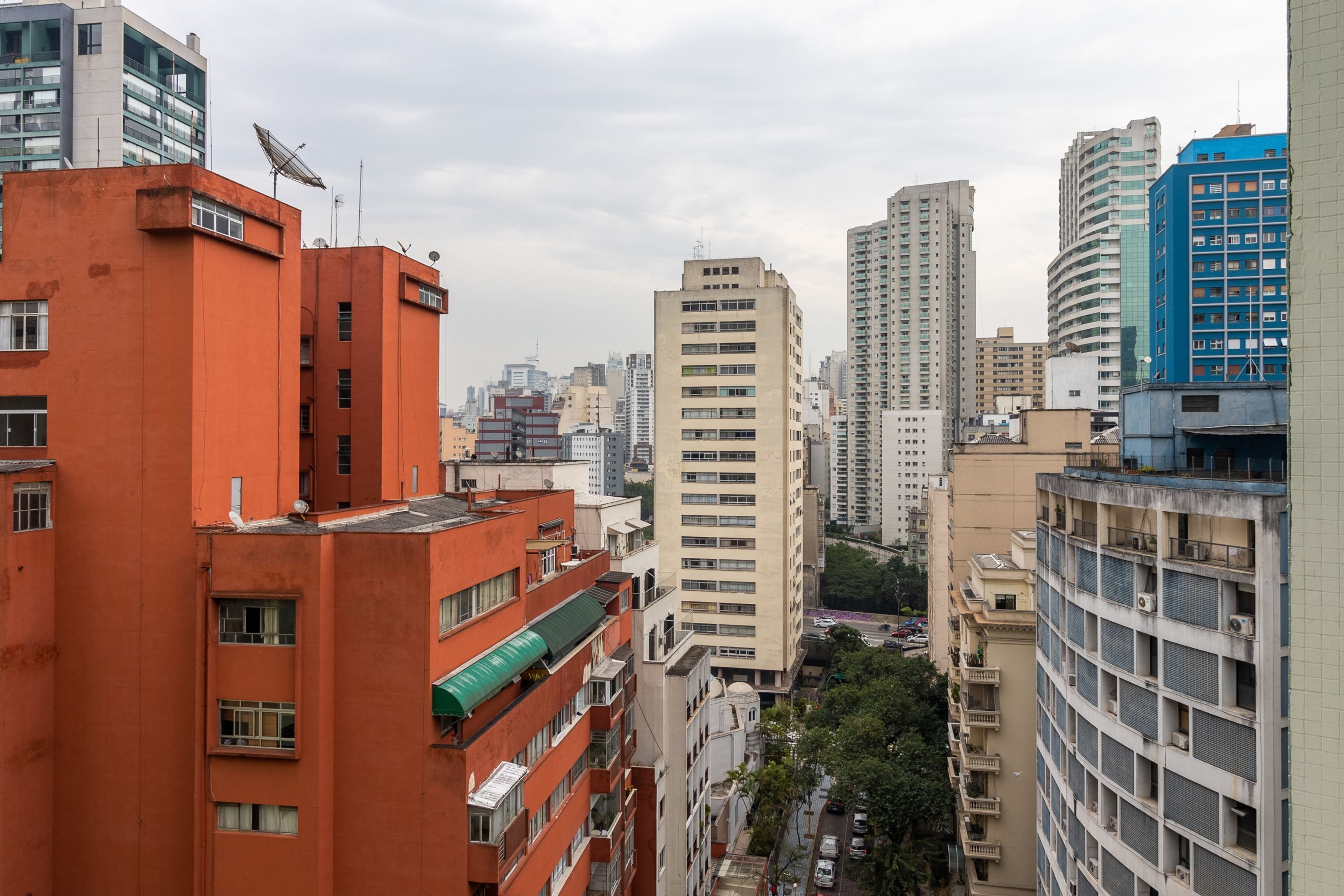 A high-rise building with multiple floors, large windows, and a flat roof.