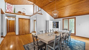 A spacious dining area with a wooden ceiling, a large table, and chairs. There is a sign on the wall and a window with blinds. - 💦 Grande Villa – Lake Cumberland View • Game Room • Walk to Boat Ramp ➠ 389 (Somerset)