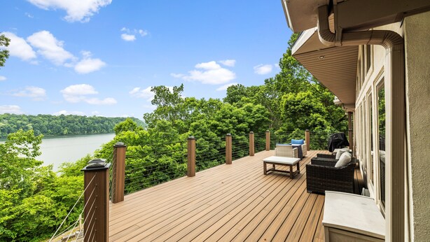 A wooden deck with outdoor furniture, overlooking a lake and forest. - 💦 Grande Villa – Lake Cumberland View • Game Room • Walk to Boat Ramp ➠ 389 (Somerset)