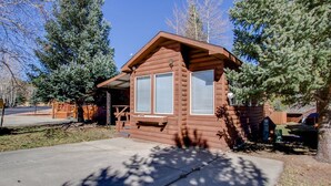 A small log cabin with a porch and a garage. - Peak Escape | Sleep Number Bed + Clubhouse Perks (Breckenridge)