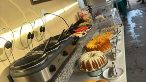 A buffet setup with various food items and a coffee station. - Pousada BG Lençóis (Barreirinhas)