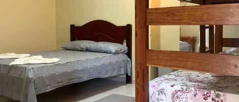 A room with a bunk bed and a single bed.