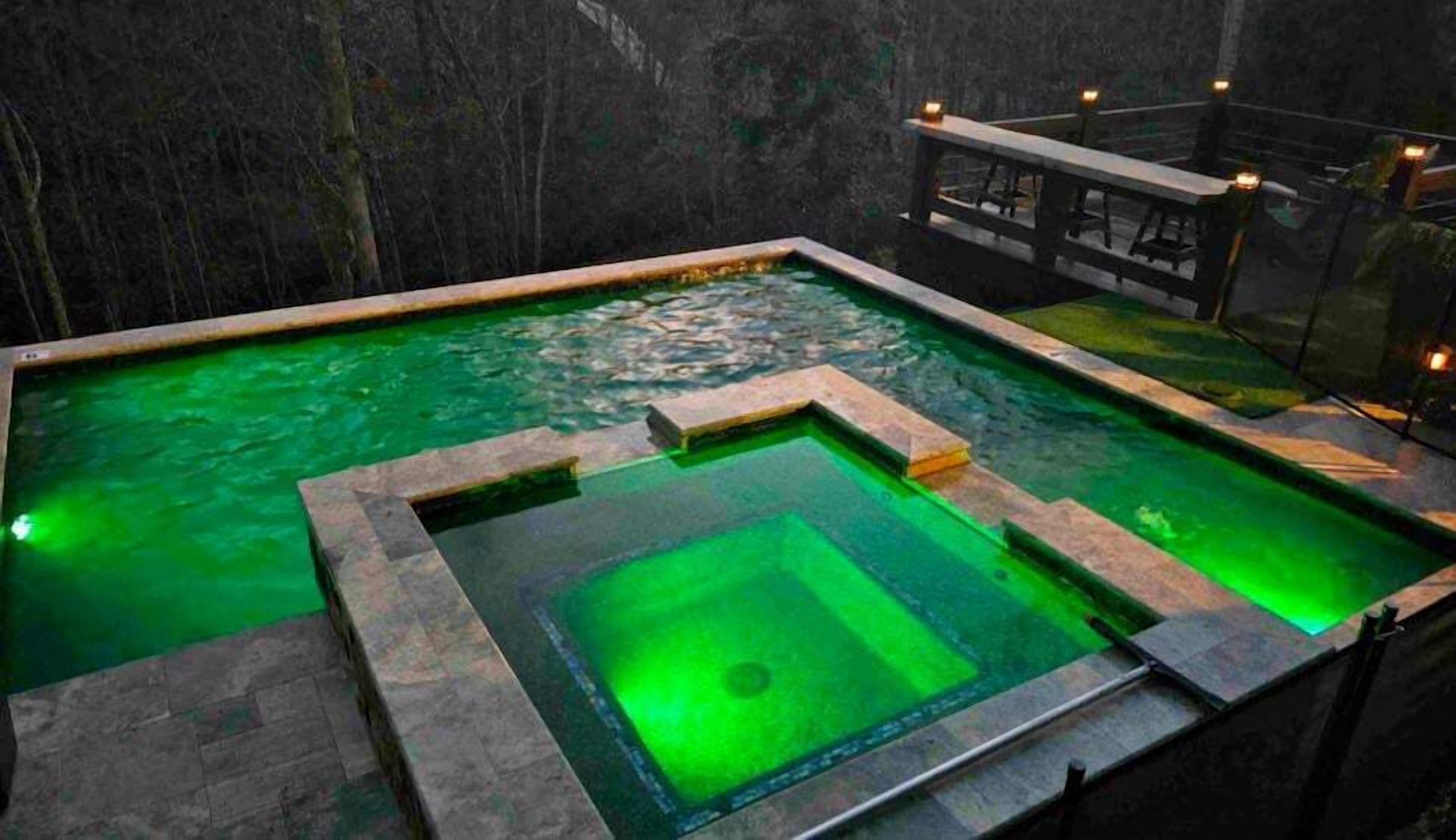 A rectangular pool with a central square section and surrounding steps.