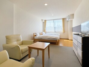 A hotel room with a bed, a desk, a chair, and a TV. - Owara View Hotel (Toyama)