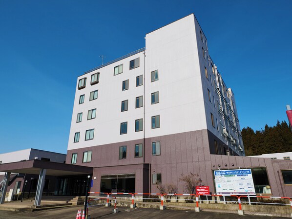 A multi-story hotel with a modern design, featuring a mix of white and purple exterior walls, large windows, and a visible entrance area with a covered walkway. - Owara View Hotel (Toyama)