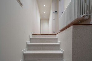 A staircase with white steps leading to a landing.