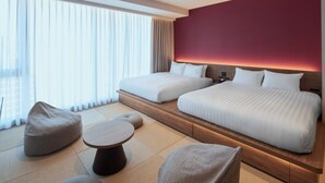 A modern hotel room with two beds, a small table, and bean bags. - FAV LUX Sapporo Susukino (Sapporo)