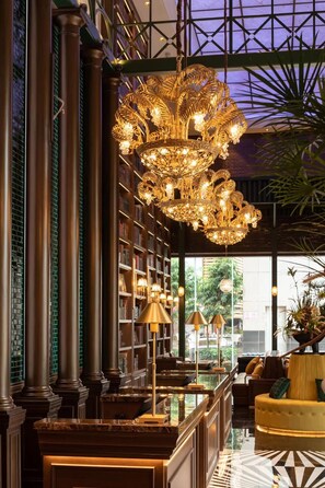 A luxurious lobby with a grand chandelier, marble flooring, and a well-stocked bookshelf. - Kaiser Hotel Guangzhou Gangding Metro (Guangzhou)