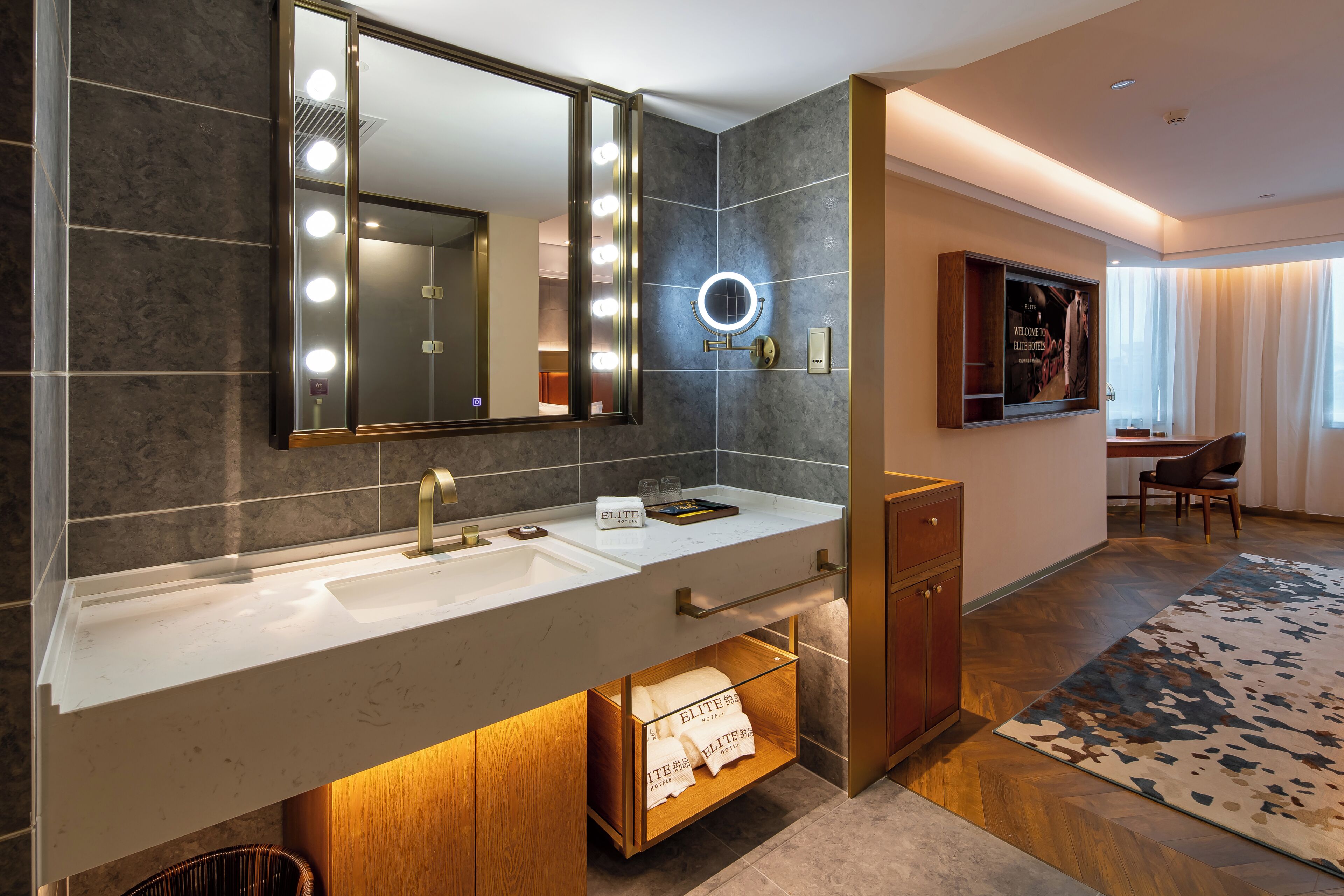 A modern bathroom with a large mirror, vanity, and a towel rack.