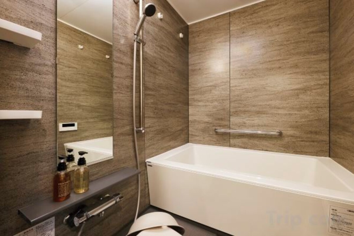 Separate tub and shower, hair dryer, slippers, towels