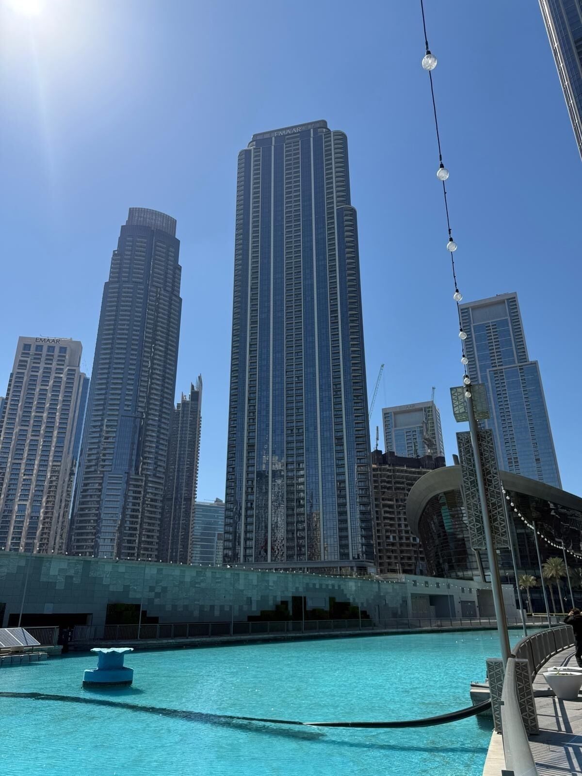 A pool area with a view of tall buildings in the background.