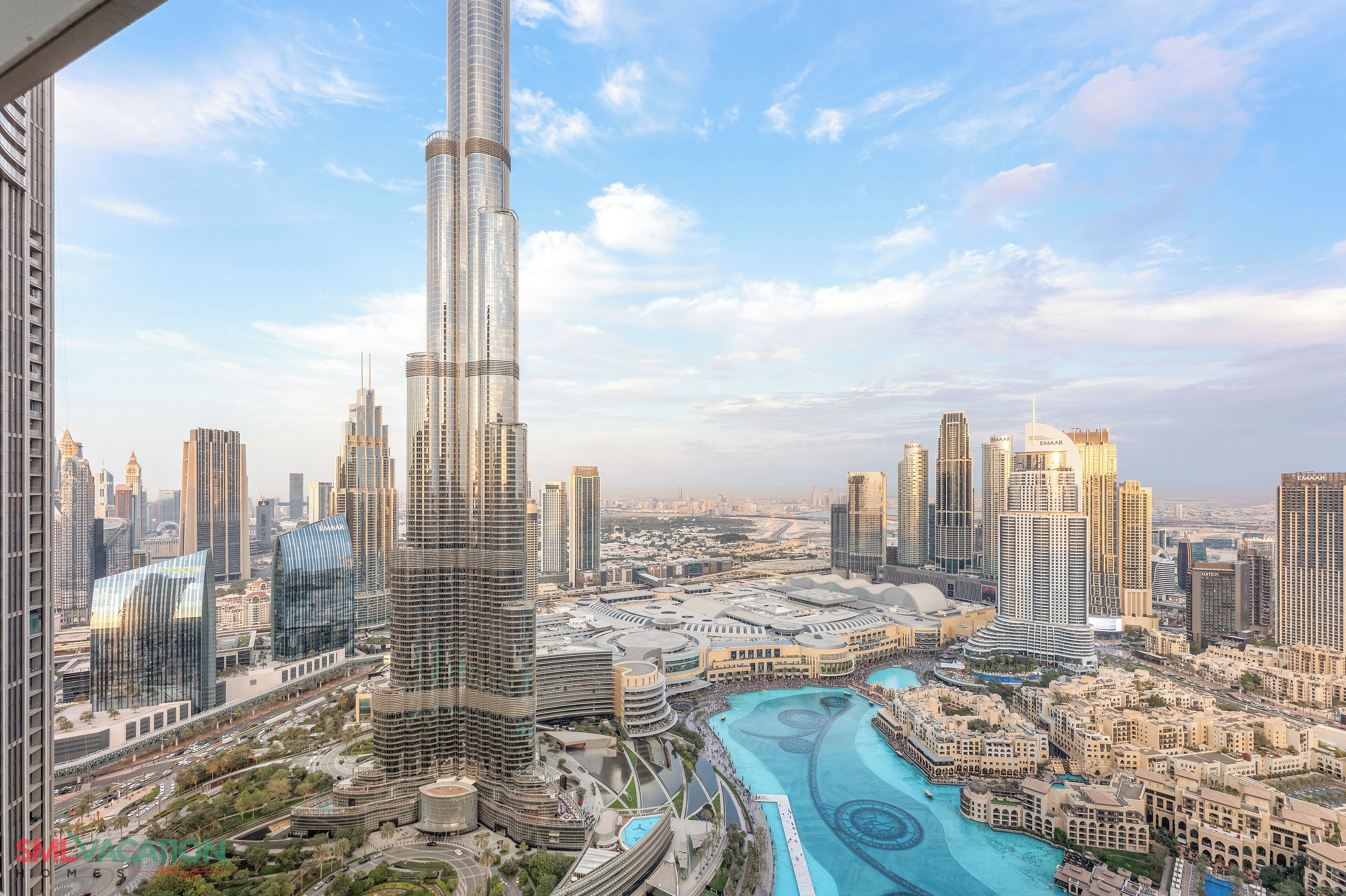 A cityscape with a prominent skyscraper, a river, and surrounding buildings.