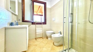A bathroom with a shower, toilet, and sink. - " Cronta Apartments with patio " (Bari Sardo)