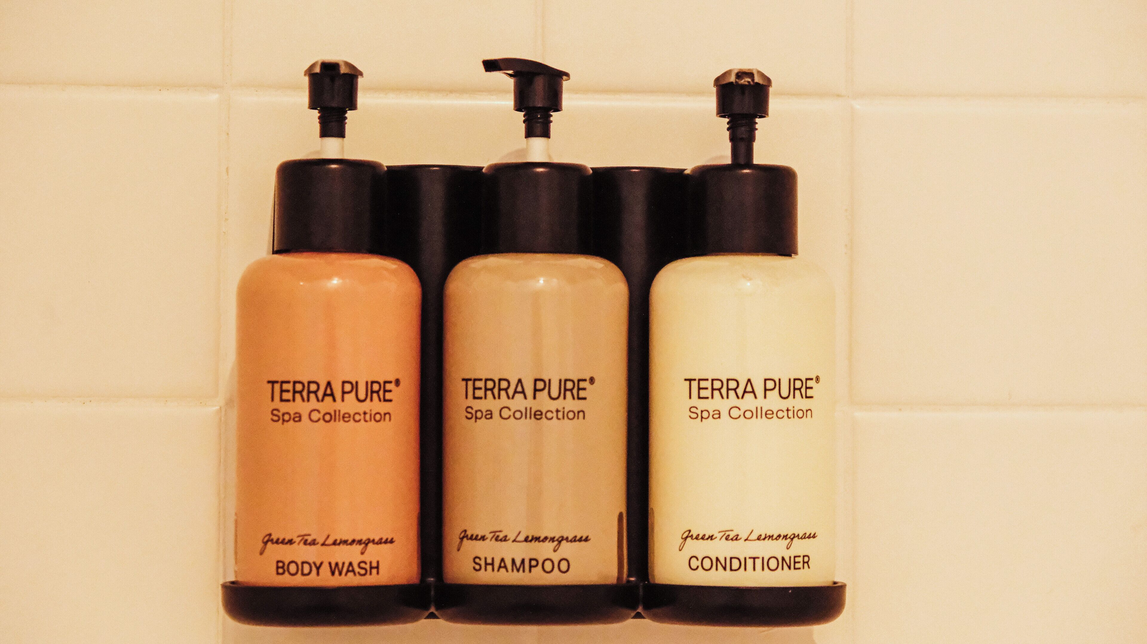 Three bottles of Terra Pure Spa Collection products: body wash, shampoo, and conditioner.