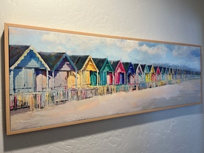 Una pintura de cabañas de playa coloridas en fila.