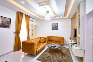 Junior Apartment, 1 King Bed with Sofa bed, Balcony | Living area | 50-inch Smart TV with cable channels