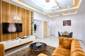 Junior Apartment, 1 King Bed with Sofa bed, Balcony | Living area | 50-inch Smart TV with cable channels