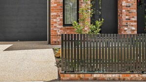 A modern two-story house with a brick facade and a dark grey roof. - St Helens I Stunning Family Townhouse in Geelong (Rippleside)