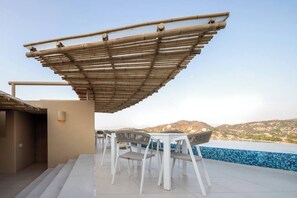 Relax on the shaded outdoor terrace with a pool and mountain views.