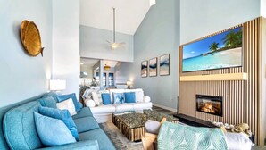 A modern living room with a sofa, coffee table, and fireplace.