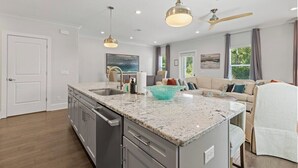 A modern kitchen with granite countertops, stainless steel appliances, pendant lighting, and a ceiling fan. - Private Pool + 6  ppl Golf Cart - Blue Mtn. Beach (Santa Rosa Beach)