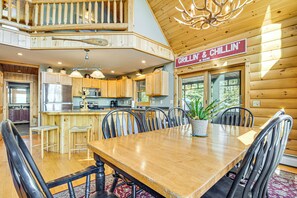 Enjoy meals and socialize in this welcoming kitchen with a central island, dining area, and high ceiling.