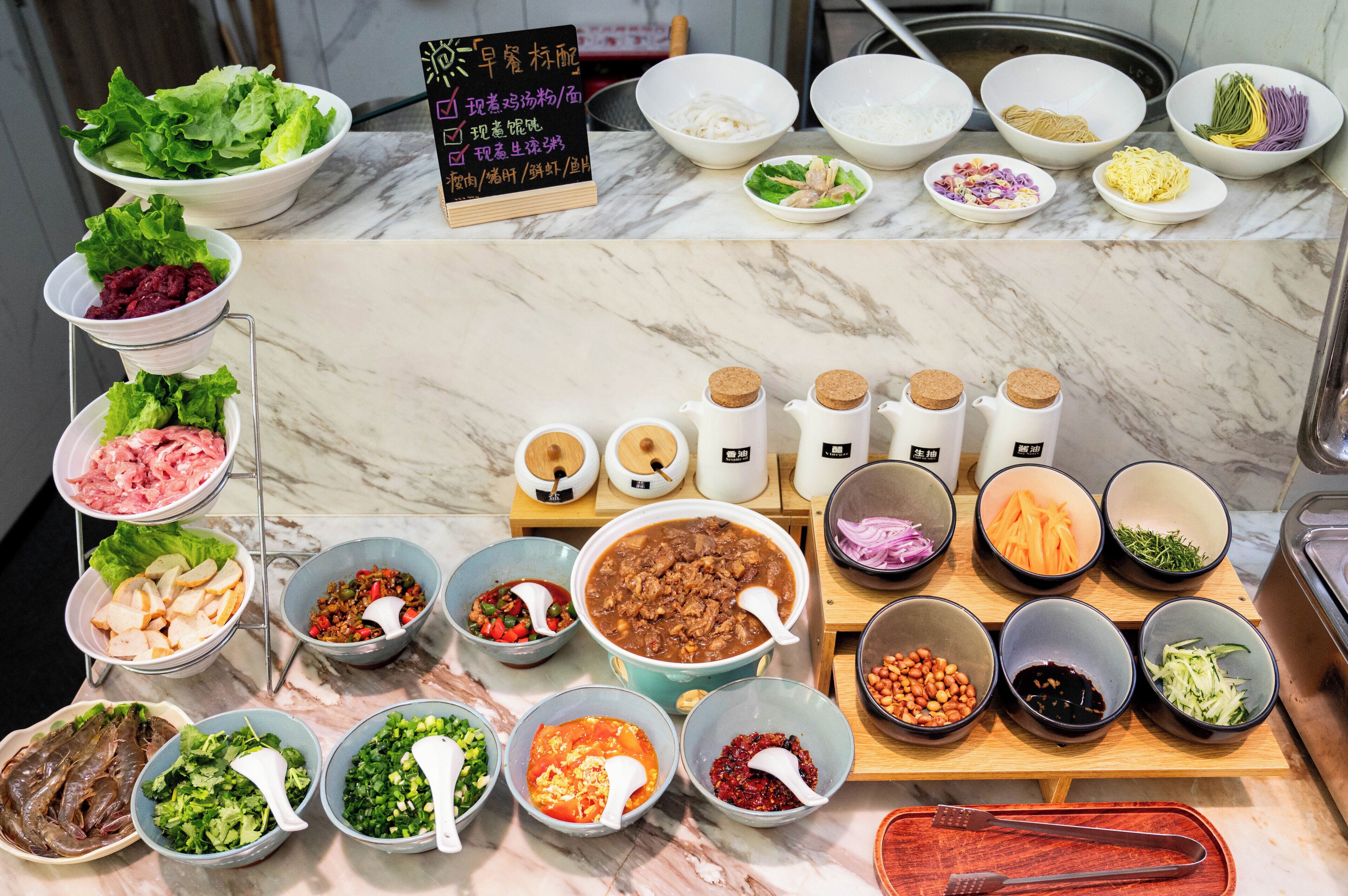 A variety of food items and condiments arranged on a marble countertop.