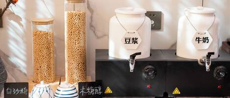 A kitchen area with jars labeled in Chinese, a coffee machine, and a sign indicating a warning.