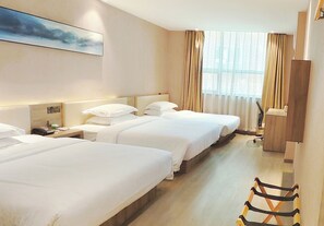 A hotel room with three beds, a wooden floor, a large window with curtains, and a painting on the wall. - Sanyuan Hotel Wuling Square Store (Chenzhou)