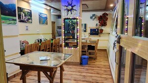 A dining area with wooden furniture, a central mirror, and a ceiling with recessed lighting. - Hotel HILL Mount View Dalhousie Chamba  (Dalhousie)