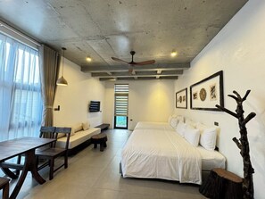 Deluxe Quadruple Room | Pillowtop beds, desk, blackout drapes, soundproofing